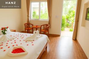 a hotel room with a bed with roses on it at S79 Blue in Phu Quoc