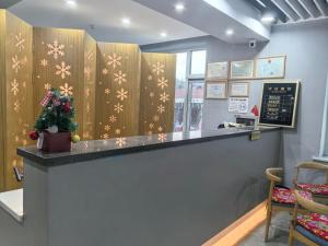 a bar in a restaurant with snowflakes on the wall at Jingbei Hotel Erlanghe Scenic Area Branch in Yushu +93 photos