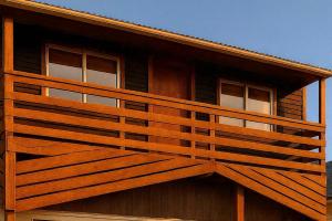 a wooden balcony on the side of a building at Cabañas Puerto Natales centro in Puerto Natales