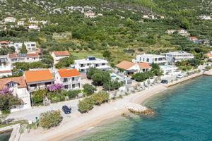 an aerial view of a beach with houses at Apartments by the sea Viganj, Peljesac - 24663 in Orebić