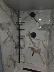 a shower with a white marble wall and a shower at Private Area & Access to Home, Rooms In Bayshore in Bay Shore +56 photos