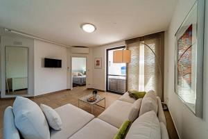 a living room with a white couch and a window at Apartments by the sea Viganj, Peljesac - 24663 in Orebić