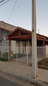 a white fence in front of a house at Casa en Graneros in Graneros