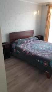 a bedroom with a bed with a quilt on it at Casa en Graneros in Graneros +13 photos