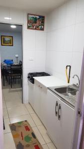 a kitchen with a sink and a kitchen with a table at Casa en Graneros in Graneros