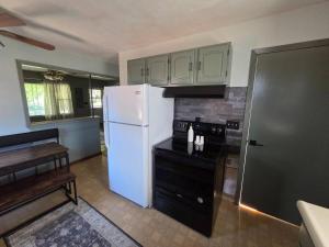 a kitchen with a white refrigerator and a stove at The Nelson House in Winner +26 photos