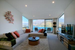 a living room with a couch and a tv at Birch Haven Spa and Views in Queenstown +19 photos