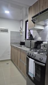 a kitchen with a stove and a sink at Epic Sun in Punta Cana