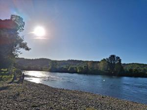 two people standing on the shore of a river at Ribera Calle Calle in Valdivia