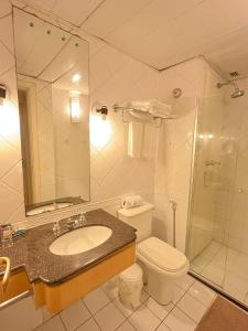 a bathroom with a sink and a toilet and a shower at Hotel Jardins Univer Pamplona com garage coz 2709 in Sao Paulo