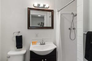 a bathroom with a sink and a toilet and a mirror at Fife Lake Lodge Multi-Level Lake View King Suite in Fife Lake +47 photos