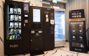 two vending machines in a store next to a refrigerator at On & Off Hotel in Incheon