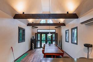a dining room with a wooden table and chairs at TID TID Yamanakako in Yamanakako