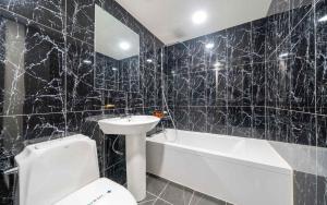 a bathroom with a sink and a toilet and a bath tub at On & Off Hotel in Incheon +13 photos