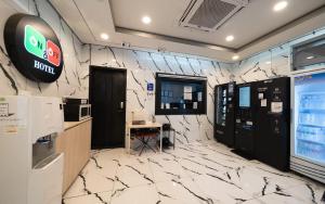 an office with a lobby with white marble walls at On & Off Hotel in Incheon
