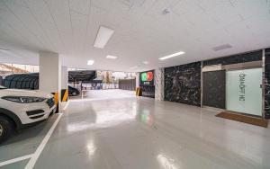 a parking garage with a car parked in it at On & Off Hotel in Incheon +4 photos