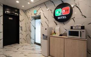 an office with a hotel sign on a wall at On & Off Hotel in Incheon