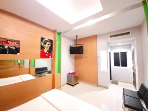 a room with a room with a tv and a room with a room at Save Hotel เซฟ โฮเทล in Chon Buri