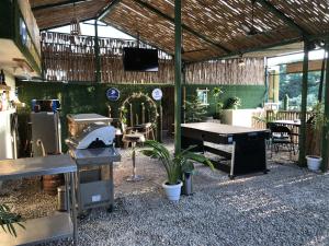 a patio with a grill and a table and a television at Hotel Peaceland Lumbini in Lumbini