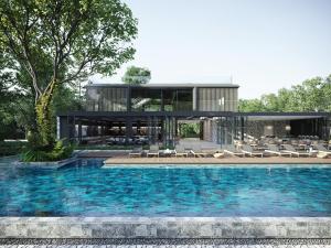 a house with a swimming pool in front of a house at MontAzure Resort Phuket - MGallery Collection in Phuket Town