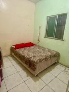 a bedroom with a bed with a red pillow on it at CASA Cop 30 in Belém +5 photos