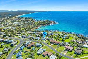 an aerial view of a suburb next to the ocean at Holiday on Noble in Dalmeny