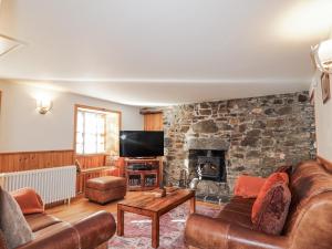 a living room with a stone wall at 83 Seatown in Buckie