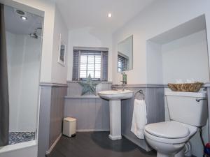 a bathroom with a toilet and a sink at 83 Seatown in Buckie +22 photos