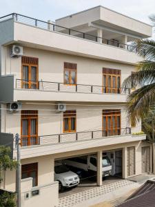 a building with cars parked in front of it at Moonlit Luxury Apartments in Piliyandala