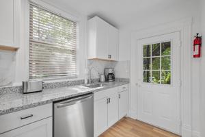 a white kitchen with a sink and a window at Pittsburgh Shadyside 2B Stylish and Cozy Private Bedroom with Shared Bathroom in Pittsburgh
