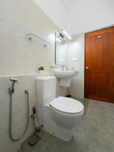 a bathroom with a toilet and a sink at Moonlit Luxury Apartments in Piliyandala