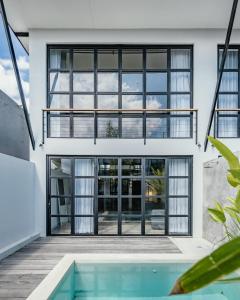 a house with a pool in front of it at Berawa Lofts #2 Canggu in Canggu
