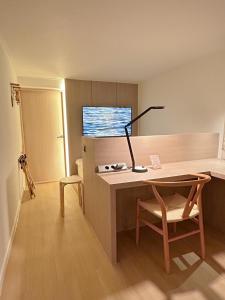 a room with a desk with a lamp and a chair at OFF STAY, hotel in Seoul - 10m from Airport, 8m to Subway in Seoul