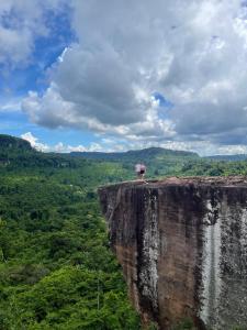 a person standing on the edge of a cliff at Joeshomestaysiemreap in Phumĭ Bœ̆ng (1)