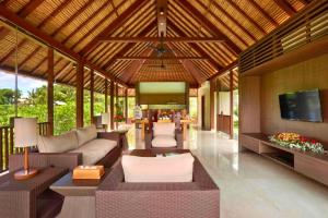 an outdoor living room with a couch and a television at Aitana 3 BR Private Pool Villa ZN286 in Blahbatu