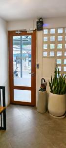 an open door with a plant in a room at B3 HOUSE in Kamala Beach