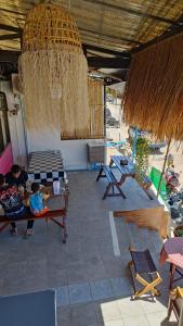 a patio with two children sitting on a table in a building at The Sunshine hostel and hotel in Ko Lanta