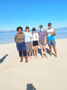 a group of people standing on the beach at Yavu room in Rakiraki +2 photos