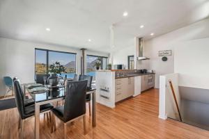 a kitchen and dining room with a table and chairs at Magical views Perfect place to stay in Frankton Wharf