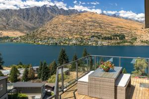 a balcony with a view of a lake and mountains at Magical views Perfect place to stay in Frankton Wharf +30 photos