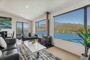 a living room with a large window with a view at Magical views Perfect place to stay in Frankton Wharf