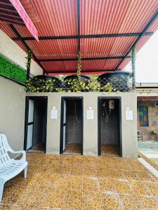 a patio with a white bench and a red ceiling at The Century Hostel George Town 乔治市世纪青旅 in George Town +35 photos