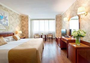 a hotel room with a bed and a desk at Roma - pyramids view in Cairo