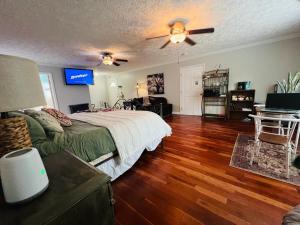 a bedroom with a bed and a ceiling fan at Tree Farm Stay Fire Pit & Grill WOW-King Suite in Fayetteville
