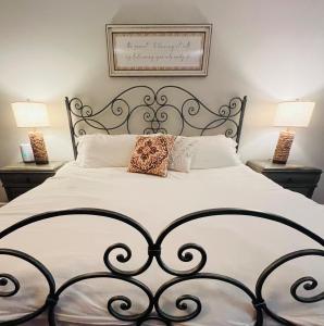 a bedroom with a large bed with two lamps at Tree Farm Stay Fire Pit & Grill WOW-King Suite in Fayetteville
