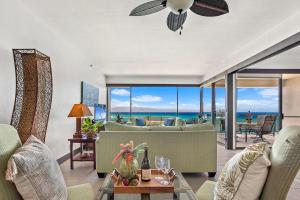 a living room with a couch and a ceiling fan at Sands of Kahana 354 · SK 354 Updated Maui OceanFront 2BD w Ocean in Kahana