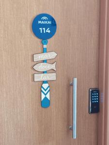 a sign on a door with a tie on it at Flat em Muro Alto, Malia Beach Experience, B114 in Porto De Galinhas