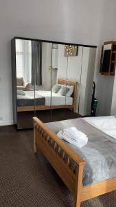 a bedroom with two beds and a large mirror at Flat In Tyne Wear Sunderland in Sunderland