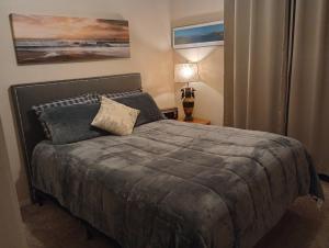 a bedroom with a bed with a gray blanket at Gem Estates Eagles nest in Emmett