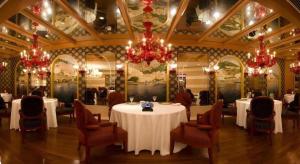 a dining room with white tables and chairs and chandeliers at Grand Lisboa Macau in Macau +177 photos